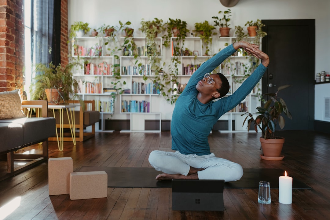 A person doing gentle floor stretches as part of a wind-down routine before sleep in a city apartment