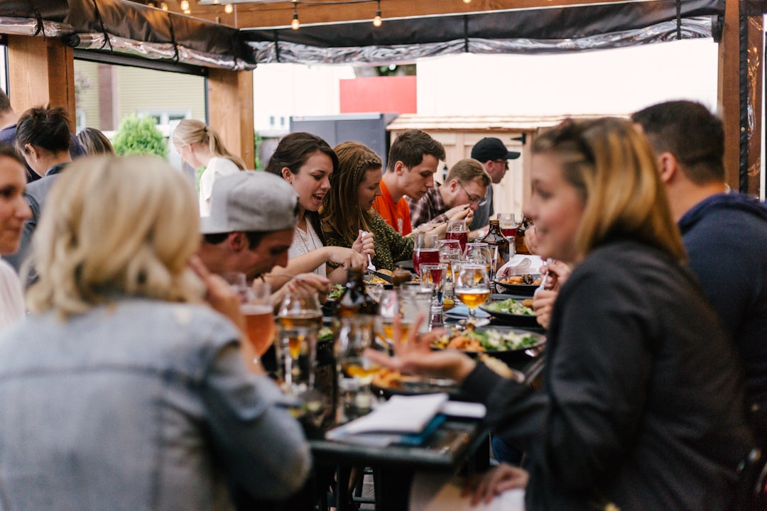 A group of friends sharing a rooftop dinner at one of New York City's most sought-after private clubs during summer