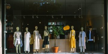 A focused entrepreneur arranging products inside a pop-up retail space in New York City