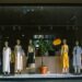 storefront-display-unsplash - NYCwebzine A focused entrepreneur arranging products inside a pop-up retail space in New York City