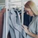 woman-browsing-sustainable-clothing-rack-unsplash - NYCwebzine A woman examines ethically made garments while building a capsule wardrobe at a New York City independent boutique