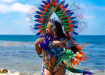 A woman in an elaborate feathered costume celebrates at the West Indian carnival parade on Eastern Parkway in Brooklyn.