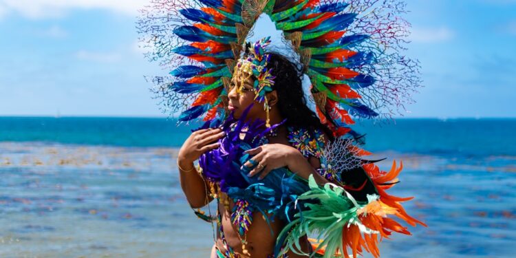 woman-dancing-caribbean-carnival-costume-unsplash - NYCwebzine A woman in an elaborate feathered costume celebrates at the West Indian carnival parade on Eastern Parkway in Brooklyn.