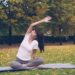woman-doing-yoga-in-park-unsplash - NYCwebzine A woman practicing yoga on a mat at an outdoor fitness class in a New York City park