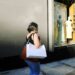 woman-shopping-clothing-unsplash - NYCwebzine A focused woman carefully examining a designer jacket at New York City sample sales, building an intentional wardrobe.