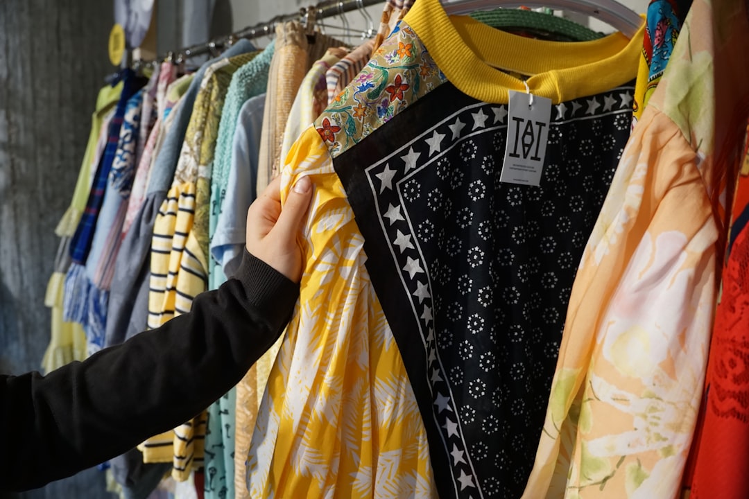 A shopper selects a sustainable piece at an independent NYC store, adding to her capsule wardrobe with care