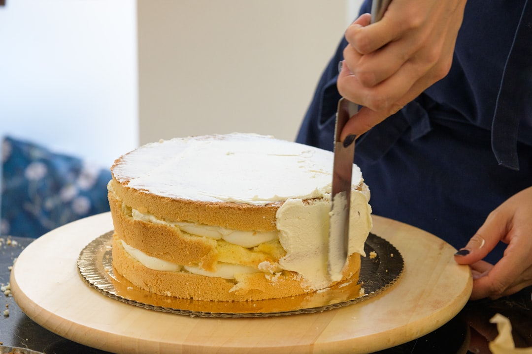 A baker decorating a cake in one of New York City's gluten-free bakeries, demonstrating the craft and attention to detail.