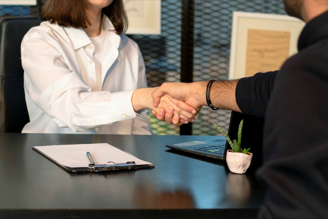 Two professionals closing a deal, representing the moment a startup lands its first customer in New York City