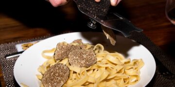 chef-shaving-truffle-over-pasta-unsplash - NYCwebzine A chef shaves fresh Alba white truffle over handmade pasta at one of New York City's most celebrated truffle dinners