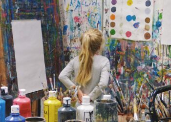 A young child painting on canvas in an after-school programmes art studio in New York City