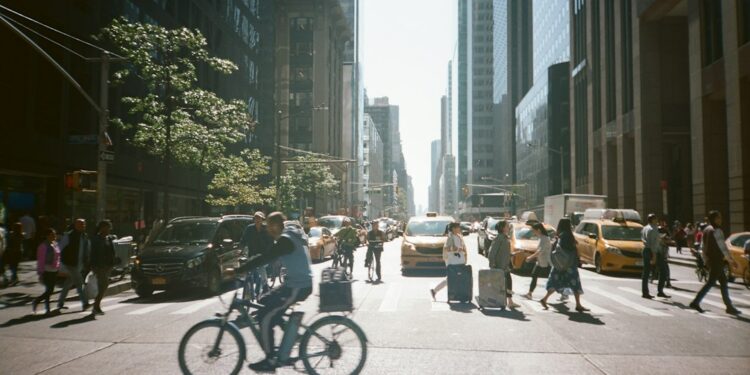 diplomat-crowd-city-street-new-york-unsplash - NYCwebzine A pedestrian walks past UN General Assembly security barriers on a busy Midtown Manhattan street