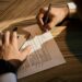 entrepreneur-signing-legal-document-office-unsplash - NYCwebzine A New York City founder reviews an NDA document to protect a business idea before a pitch meeting
