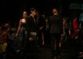 fashion-designer-backstage-runway-woman-unsplash - NYCwebzine An emerging designer adjusts a garment backstage before a New York Fashion Week runway show