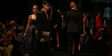 fashion-designer-backstage-runway-woman-unsplash - NYCwebzine An emerging designer adjusts a garment backstage before a New York Fashion Week runway show