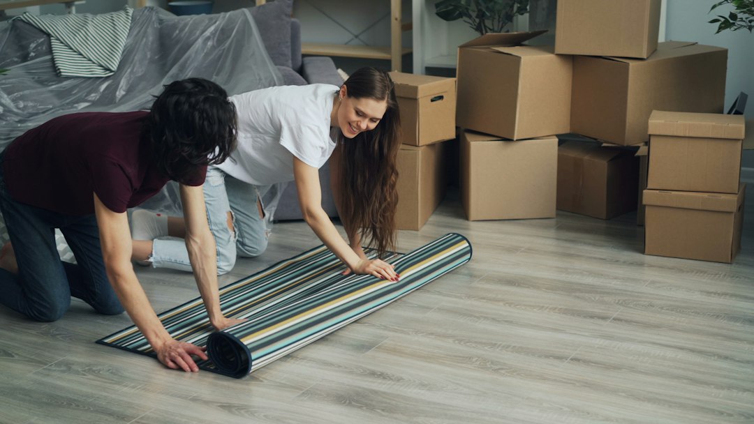 A person using a foam roller as part of a recovery routine on a living room floor, demonstrating a simple and space-efficient