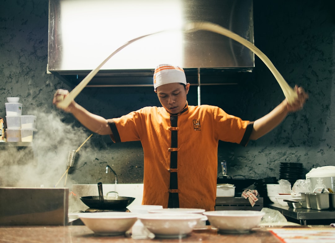 A chef carefully serves a steaming bowl at one of New York City's most celebrated ramen shops