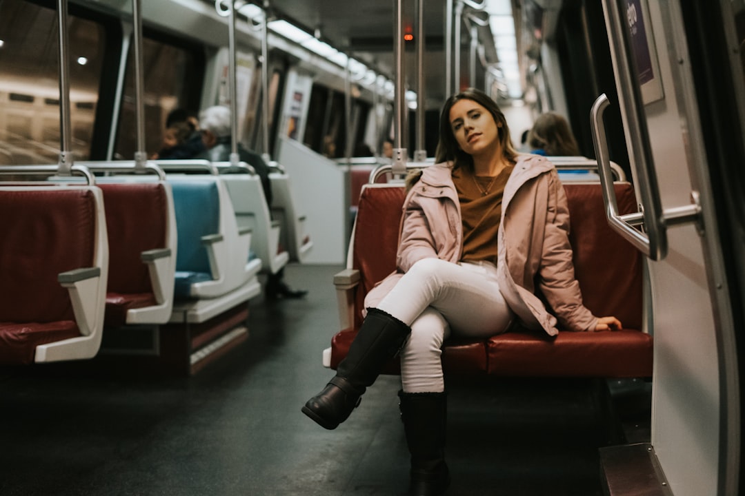 A woman descends into a New York City subway station, embracing car-free living in the urban landscape below the street.