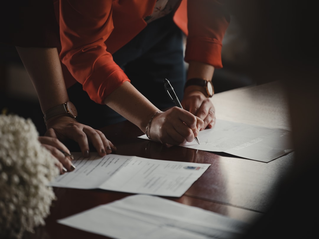 Un imprenditore determinato completa la documentazione per registrare una ditta individuale presso la scrivania di un ufficio comunale a New York