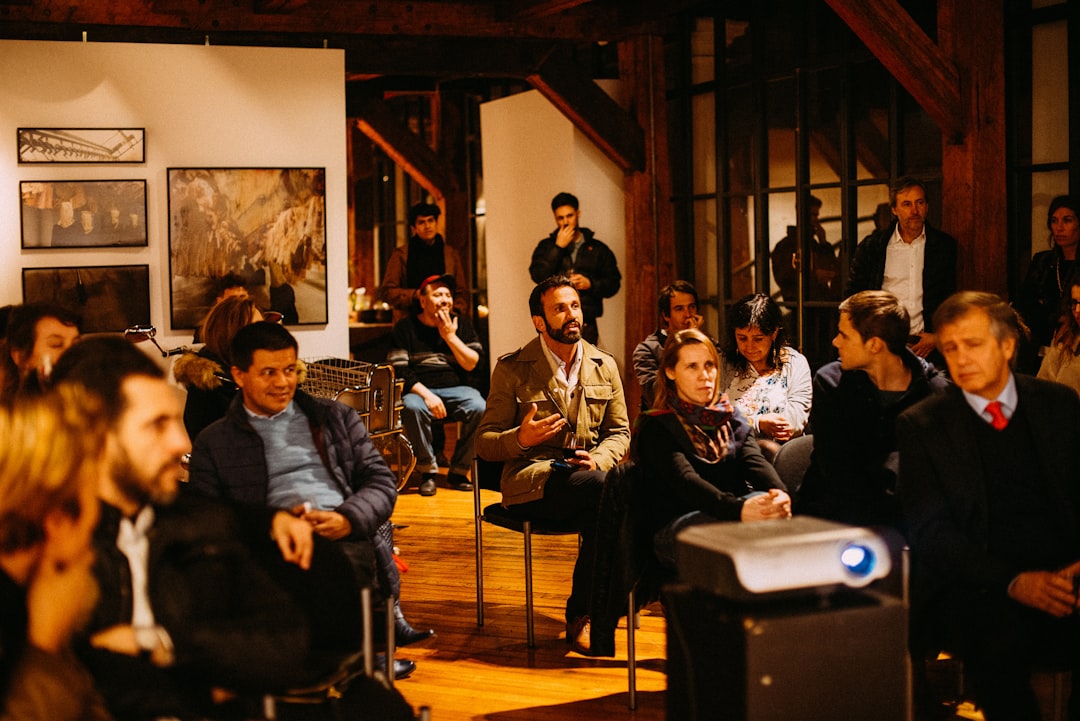 A private art advisor and collector discussing a painting in a New York City gallery, illustrating the personalized service.
