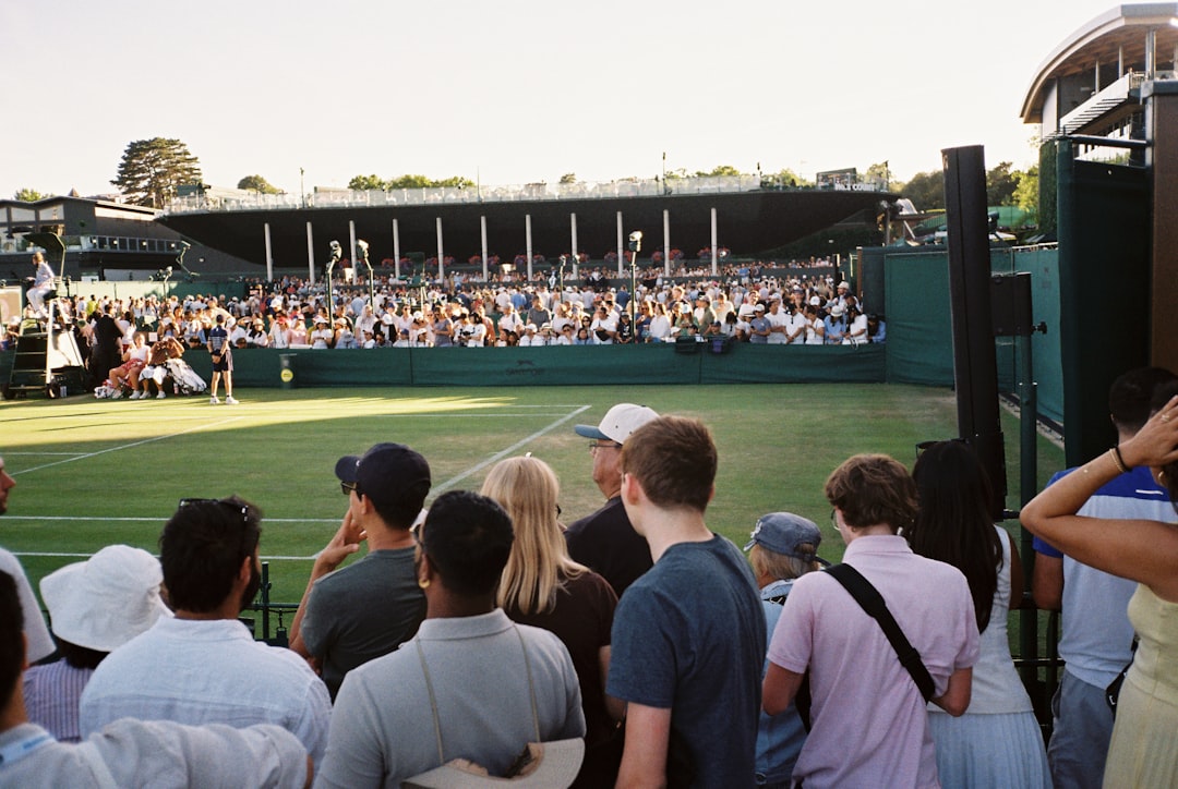 A tennis player competes in a US Open qualifying match on an outdoor hard court at Flushing Meadows