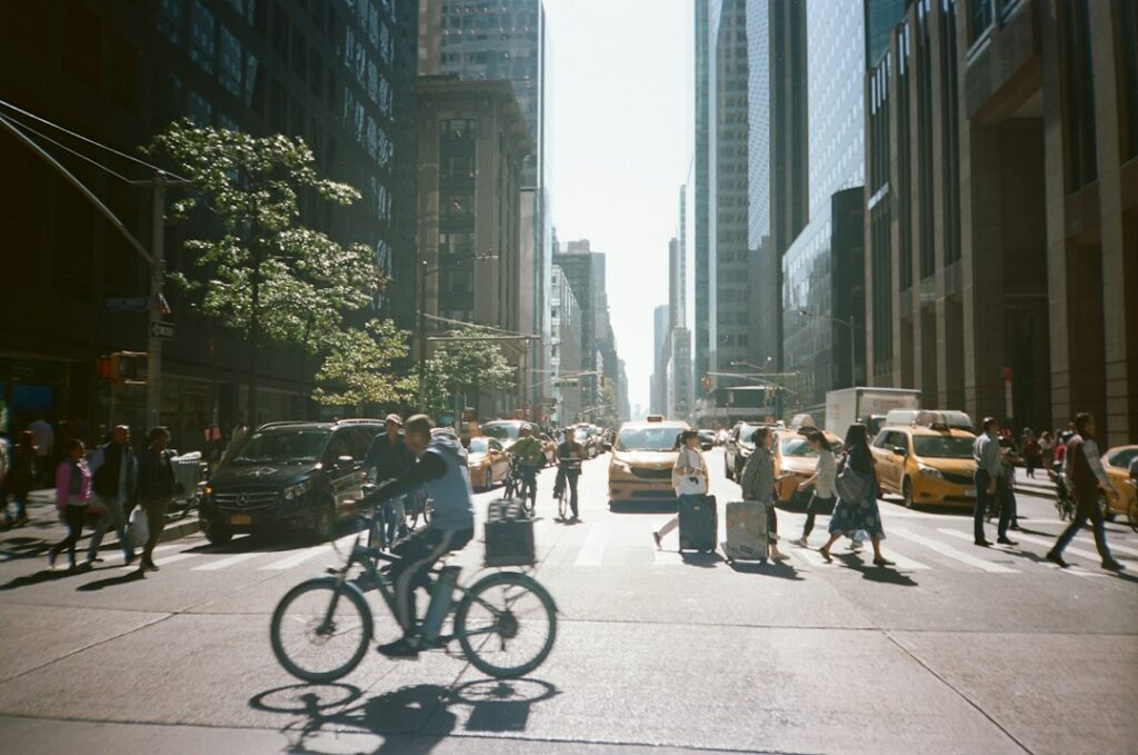 A pedestrian walks past UN General Assembly security barriers on a busy Midtown Manhattan street